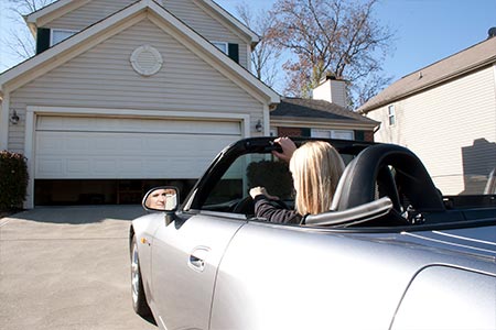 Home owner pulling up to a well maintained garage door