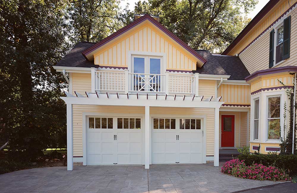 Clopay Reserve Wood Semi-Custom Garage Doors painted white on victorian home